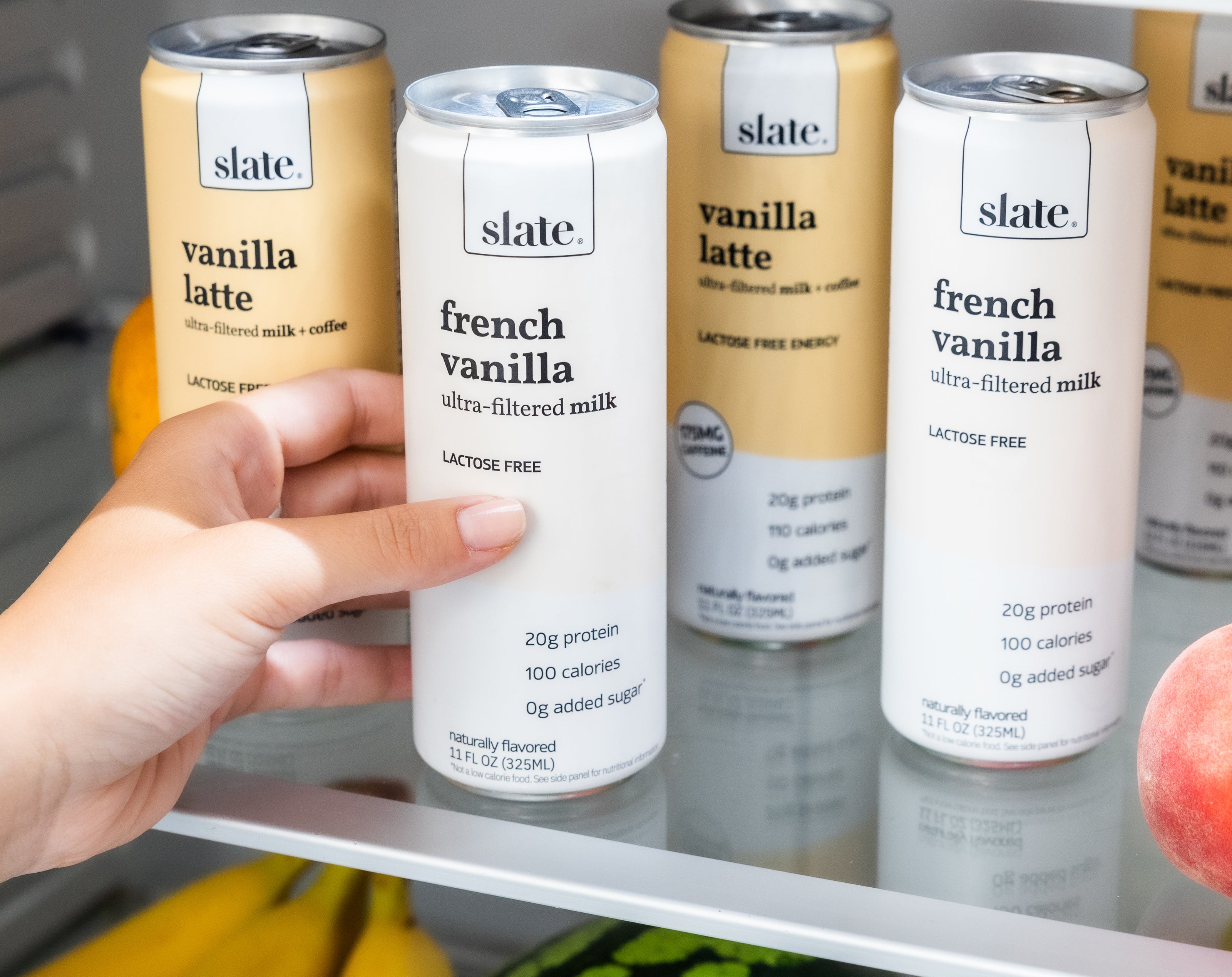 Person grabbing a can of french vanilla Slate Milk
